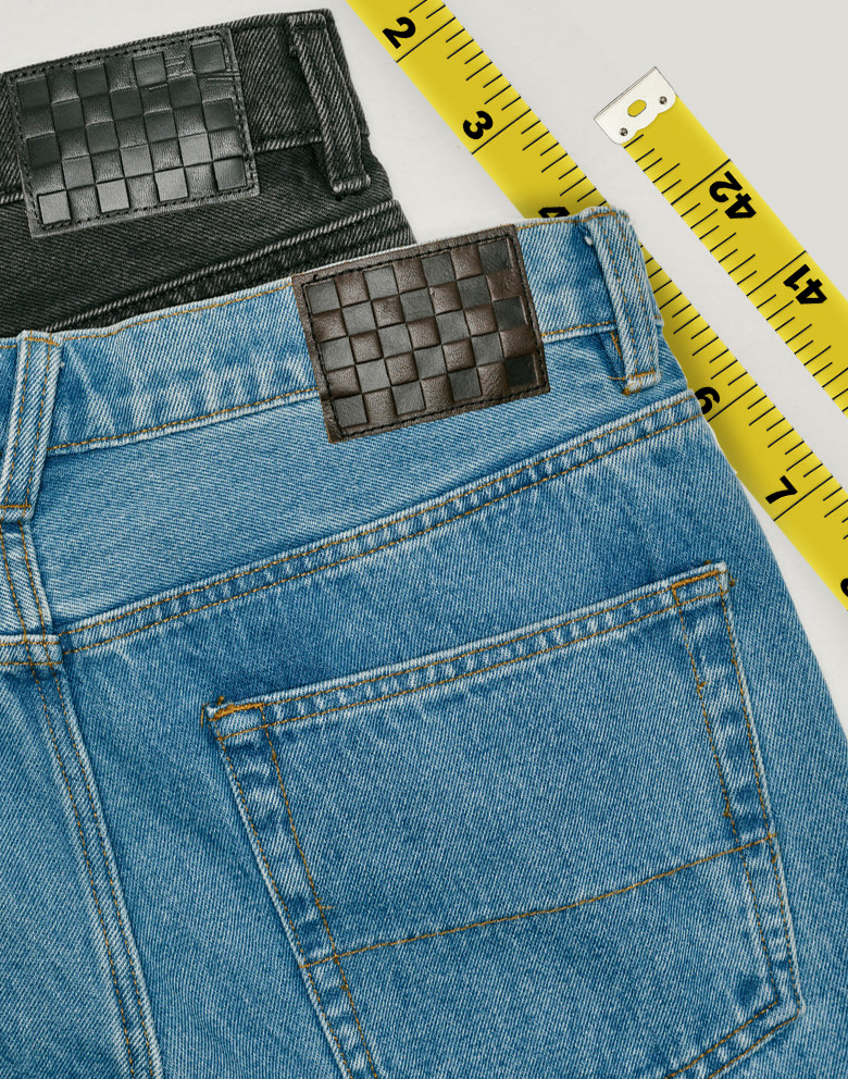 A pair of black and a pair of stonewash blue Check-5 Baggy Denim Pants stacked on top of each other.