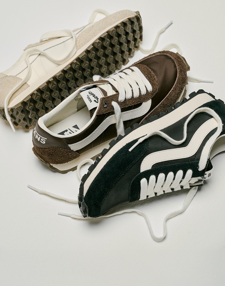 All three white, black, and brown colorways of the Premium Style 152 laid out on the floor of a photography studio.