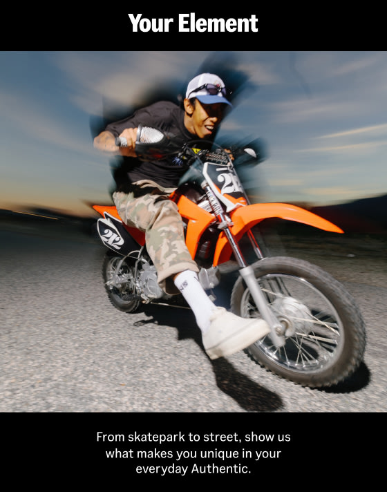 A young man riding a dirt bike wearing white Authentic and camo Drill Chore Carpenter Loose Denim Pants.