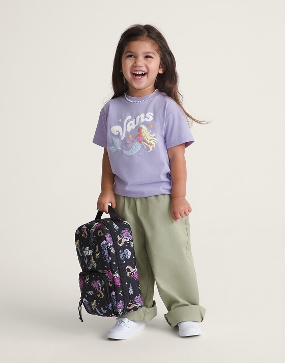 A young girl smiling at the camera wearing a purple Kids Shore Thing T-Shirt.