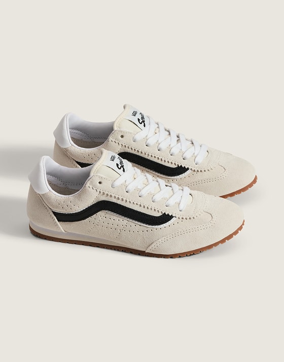 A pair of marshmallow white and black Super Lowpro shoes on the floor of a photography studio.