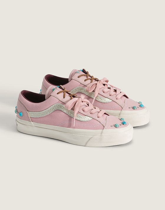 A pair of misty mauve pink Premium Old Skool 36 shoes with turquoise details on the floor of a photography studio.