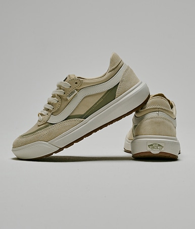 A pair of cream beige UltraRange 2.0 stacked on top of each other on the floor of a photography studio.