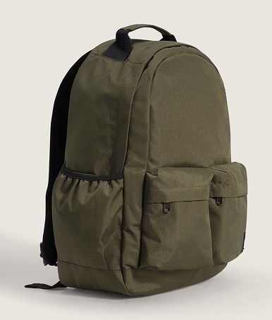 A mossy olive green Off The Wall Backpack on the floor of a photography studio.