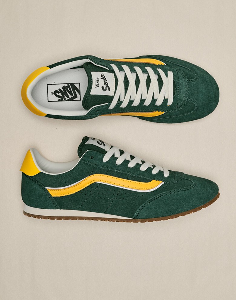 An overhead shot of the green and yellow colorway of the Super Lowpro on the floor of a photography studio.