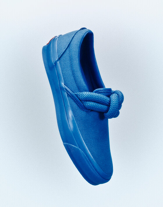 Image of the blue OTW Slip On Knot shoe floating in mid air.