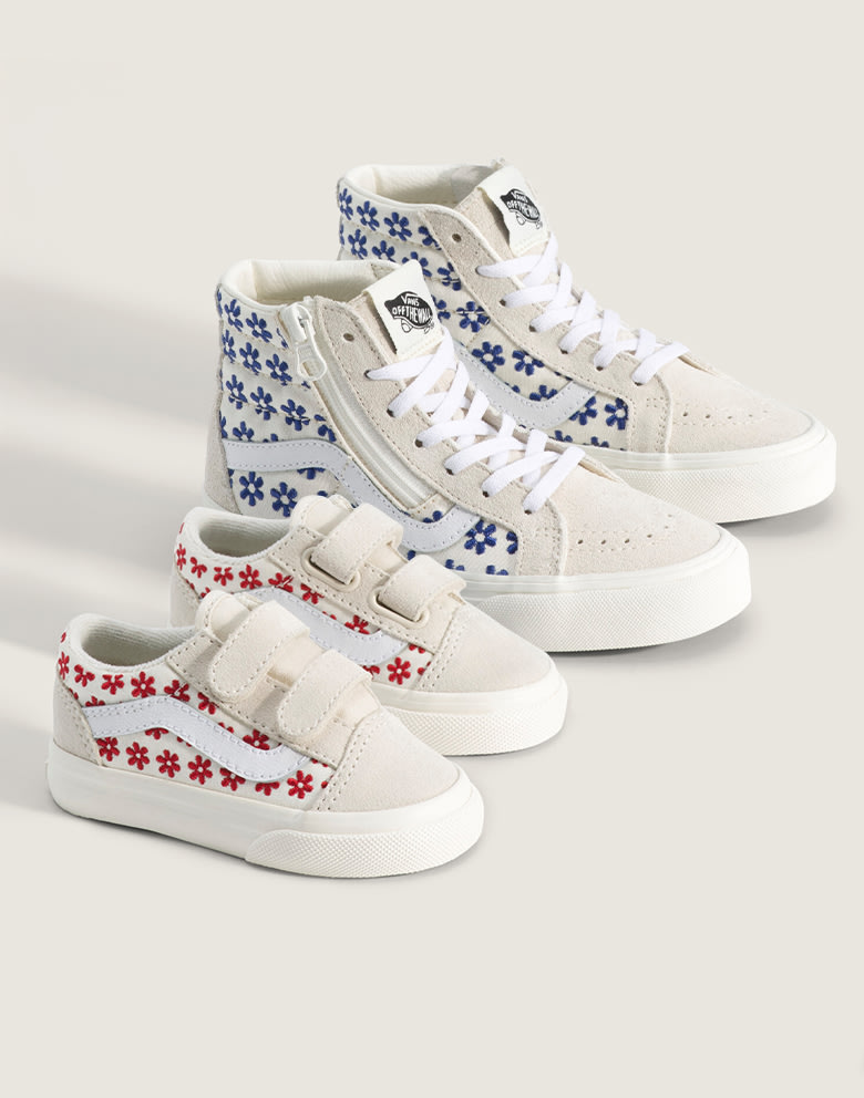 A pair of chantilly floral racing red Toddle Old Skool V and chantilly floral true blue Little Kids Sk8-Hi Side Zip in a photography studio.