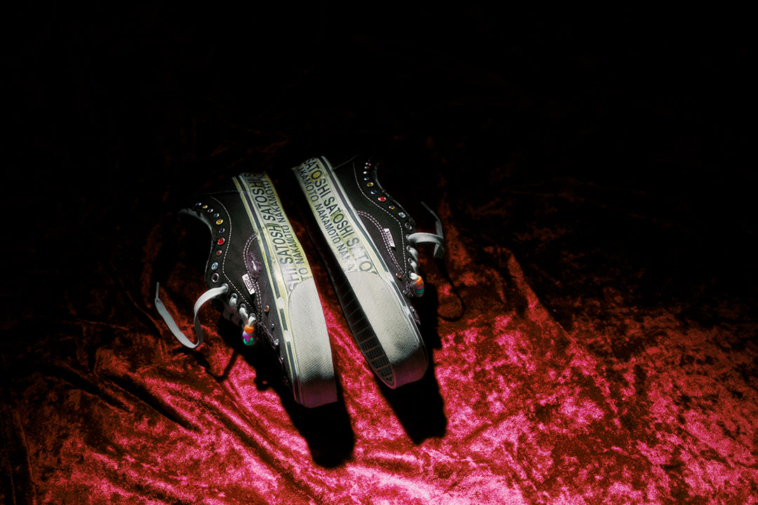 Pair of Vans x Satoshi Shoes laying on red velvet.