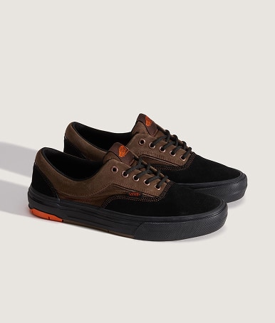 A pair of black and brown Skate Era Wafflecup shoes on the floor of a photography studio.