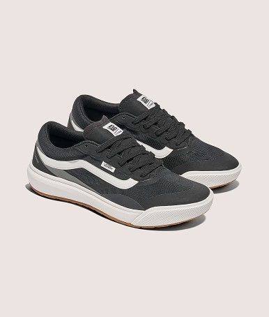 A pair of black and white UltraRange 2.0 shoes on the floor of a photography studio.