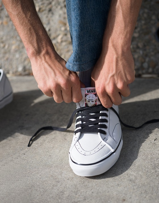 Close-up on someone lacing up white AVE Classic by Hockey on the concrete.