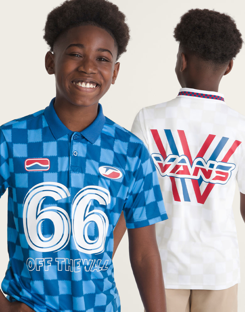 A young boy wearing the true blue Hat Trick Soccer Jersey and the white Derby Soccer Jersey in a photography studio.
