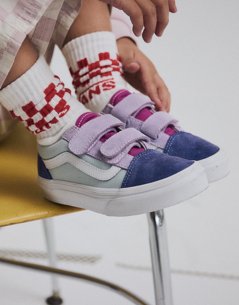 Close-up on a young girl wearing multicolored Little Kids Old Skool V Shoe with red Kids Classic Check Crew Socks.