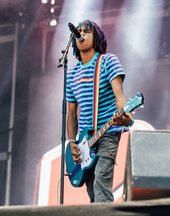 A guitarist singing into the microphone at Vans Warped Tour.