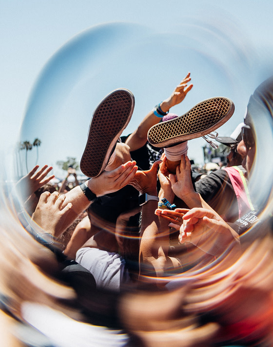 A blurry motion shot of someone crowd surfing at Vans Warped Tour.