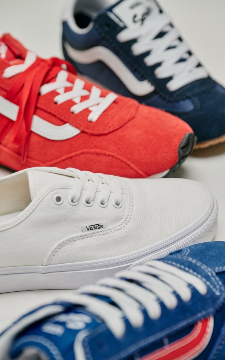 Close-up on the Super Lowpro, Authentic, and Old Skool in red, white, and blue colorways in a photography studio.