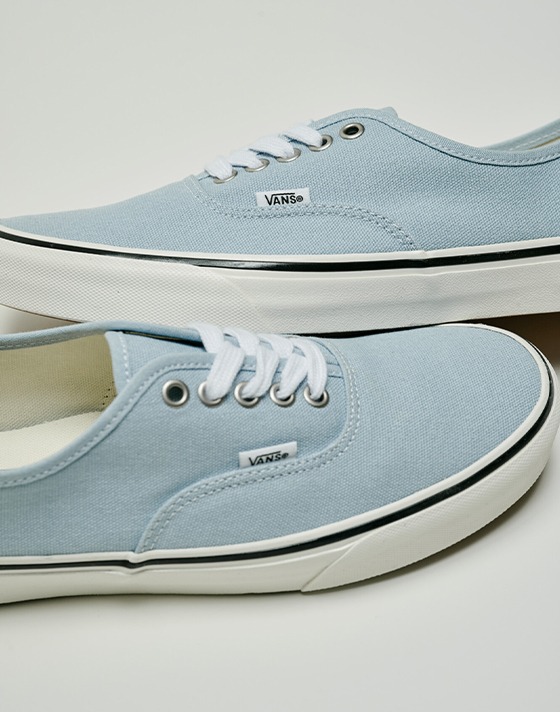 Close up of the Authentic shoe in Soft Slate Blue on the floor of a grey photography studio.
