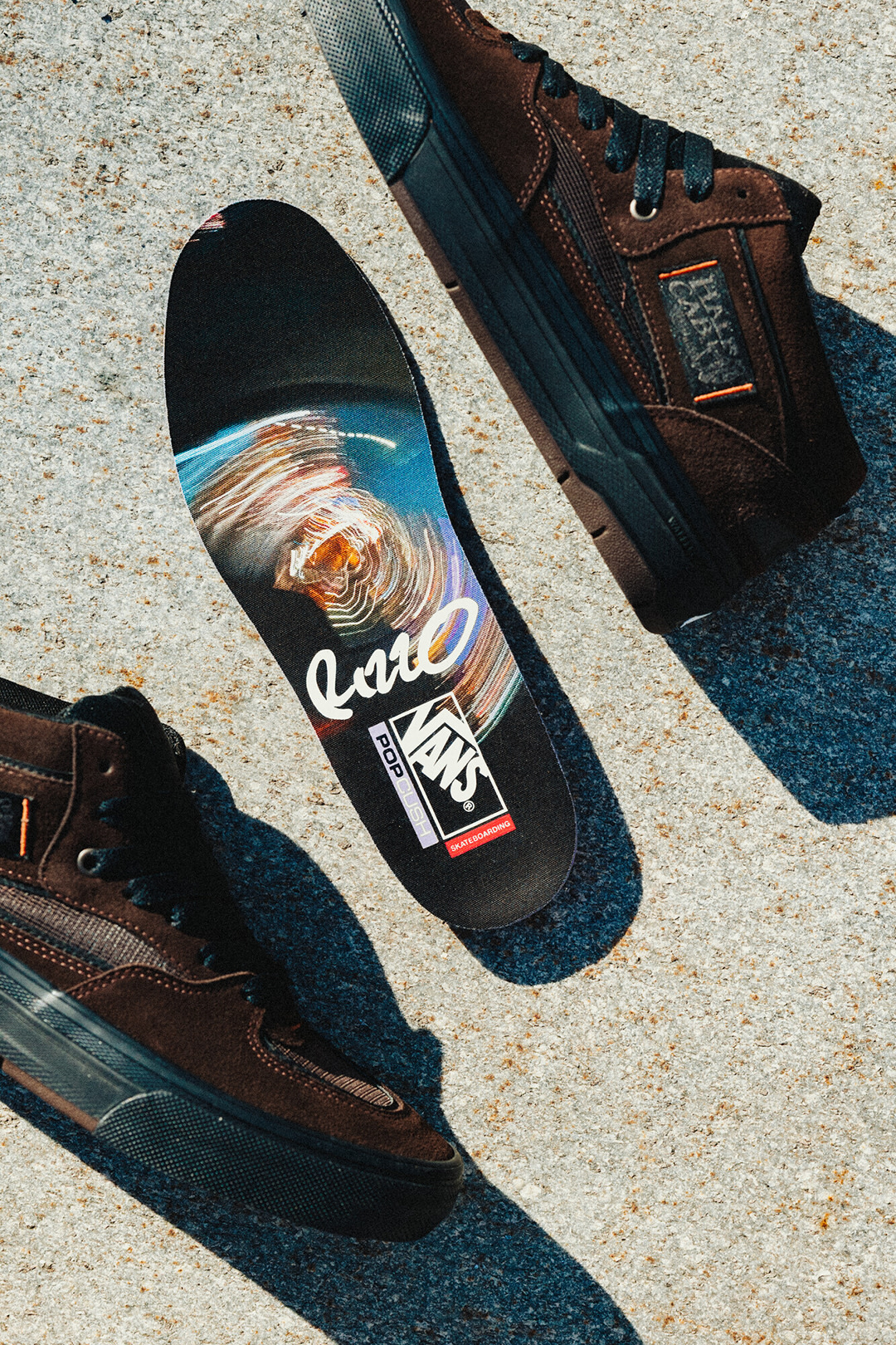 Image of the Vans Half Cab Wafflecup on the ground with one insole in between the shoes.