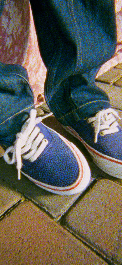 Knee down image of a person wearing the OTW authentic 44 siped vibram shoes in blue. 