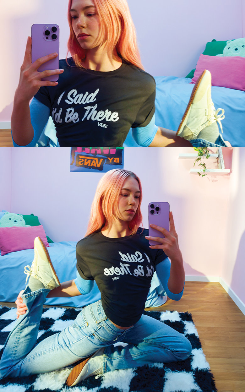 Woman with pink hair taking a selfie in her pink bedroom on her checkerboard rug wearing the Super Lowpro Ballet Light in Marshmallow White.