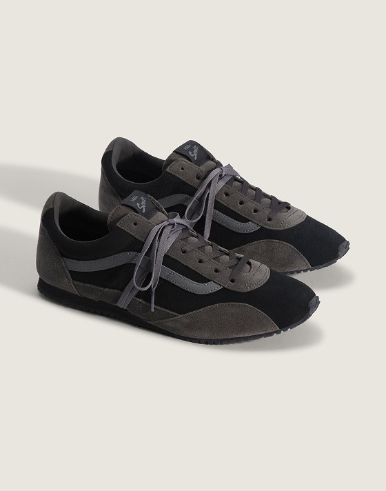 A pair of black and gray Premium Super Lowpro Trainer on the floor of a photography studio.