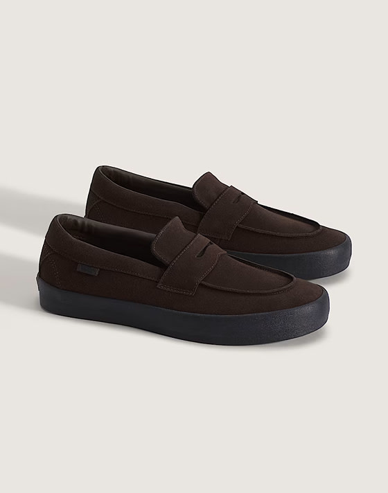 A pair of brown Skate Loafers on the floor of a photography studio.