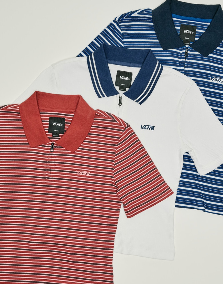 Top down shot of three Priscilla Polo Shirts. Each one slightly on top of the other. The Poppy Ember Red on top, then Egret White, then Classic Blue.