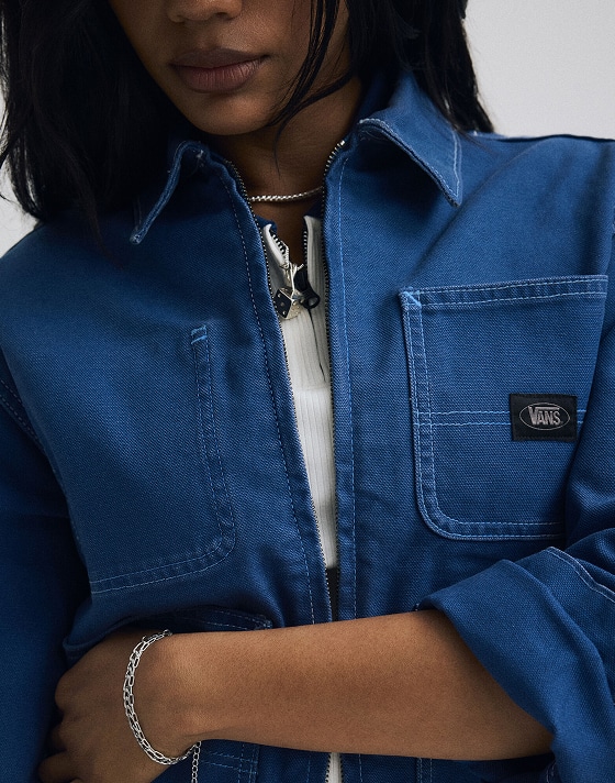 Close-up on a young woman wearing a true navy blue Emily Boxy Workwear Jacket.