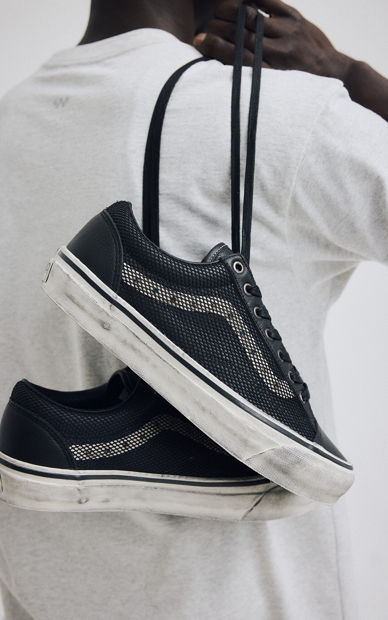 An overhead shot of a pair of gray and white Authentic on the floor of a photography studio.