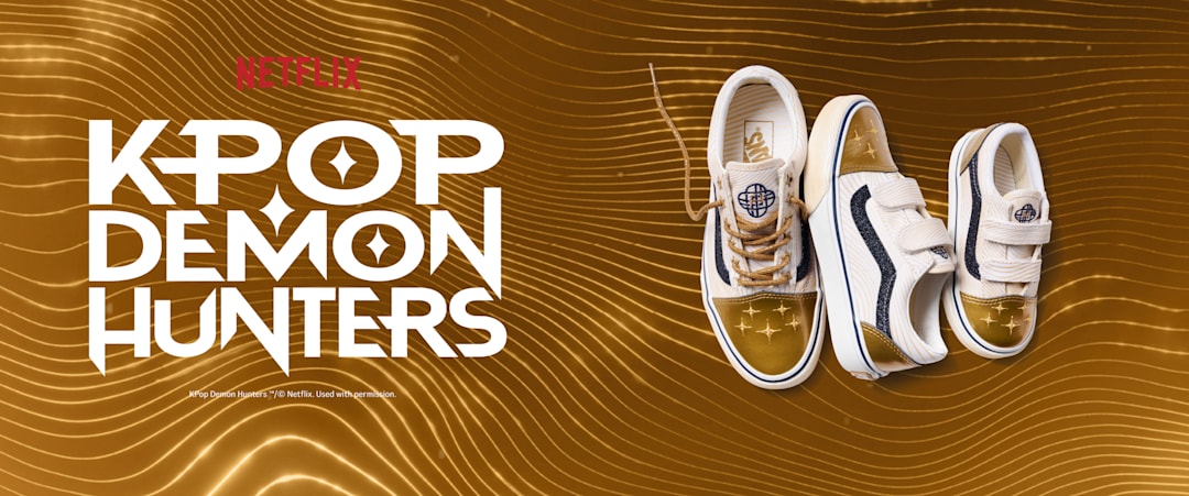 Golden background with shimmering sound waves. Netflix KPop Demon Hunters logo on the left, three Golden Old Skool sizes on the right.