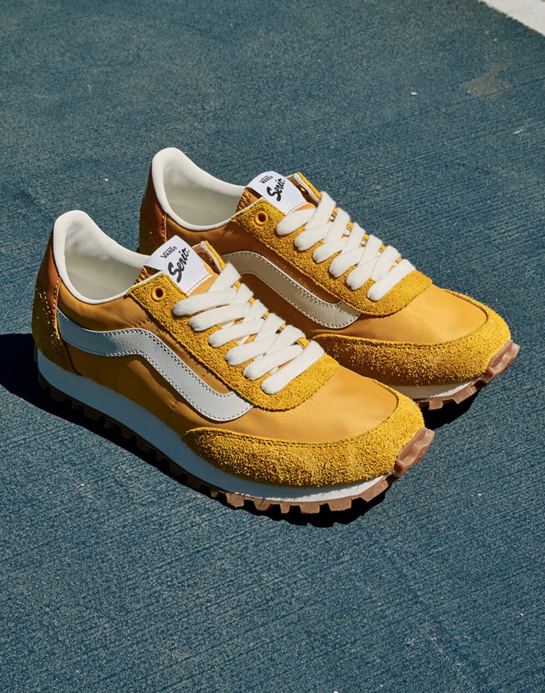 Close-up on a yellow Premium Style 152 Shoe on a carpet.