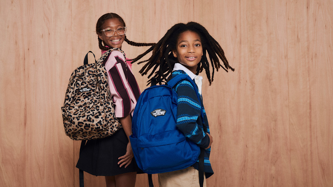Two kids wearing Vans backpack