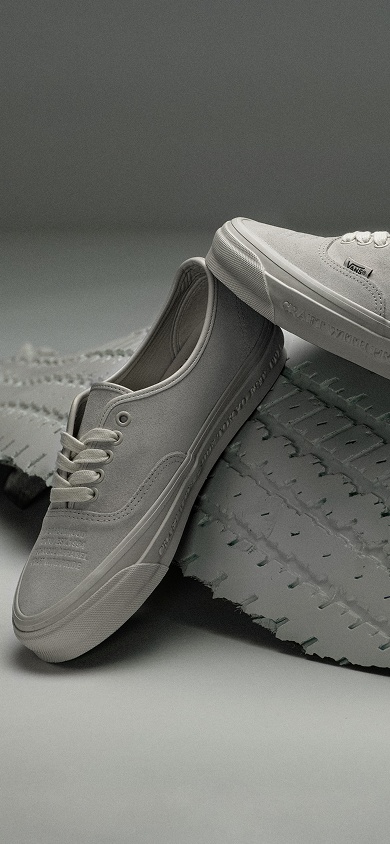 Image of the OTW by Vans x Neighborhood tan authentic shoe on top of a tan tire
