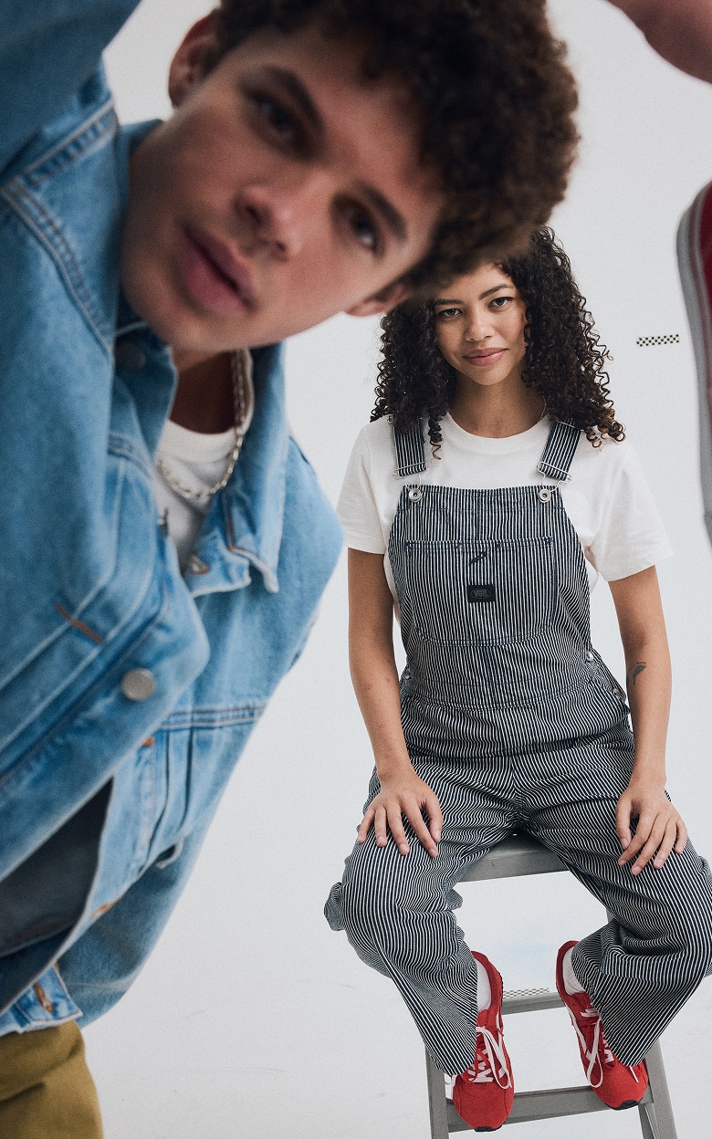 A young man and woman pose together in a photography studio wearing Vans shoes and clothes for the Labor Day Sale.