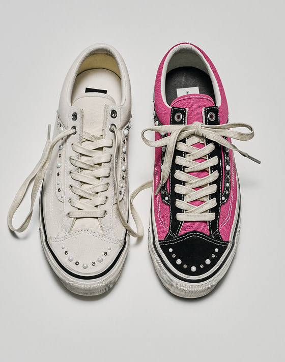 A white colorway next to a pink and black colorway on the Premium Old Skool 36 Pearlized shoe.