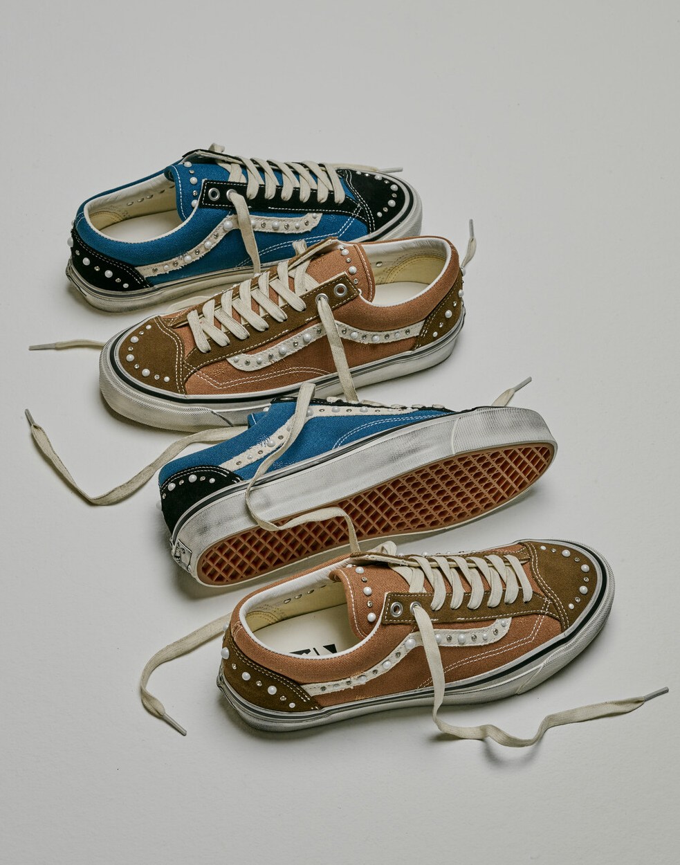 Two pairs of Premium Old Skool 36 Pearlized shoes lined up in a row with a white background.