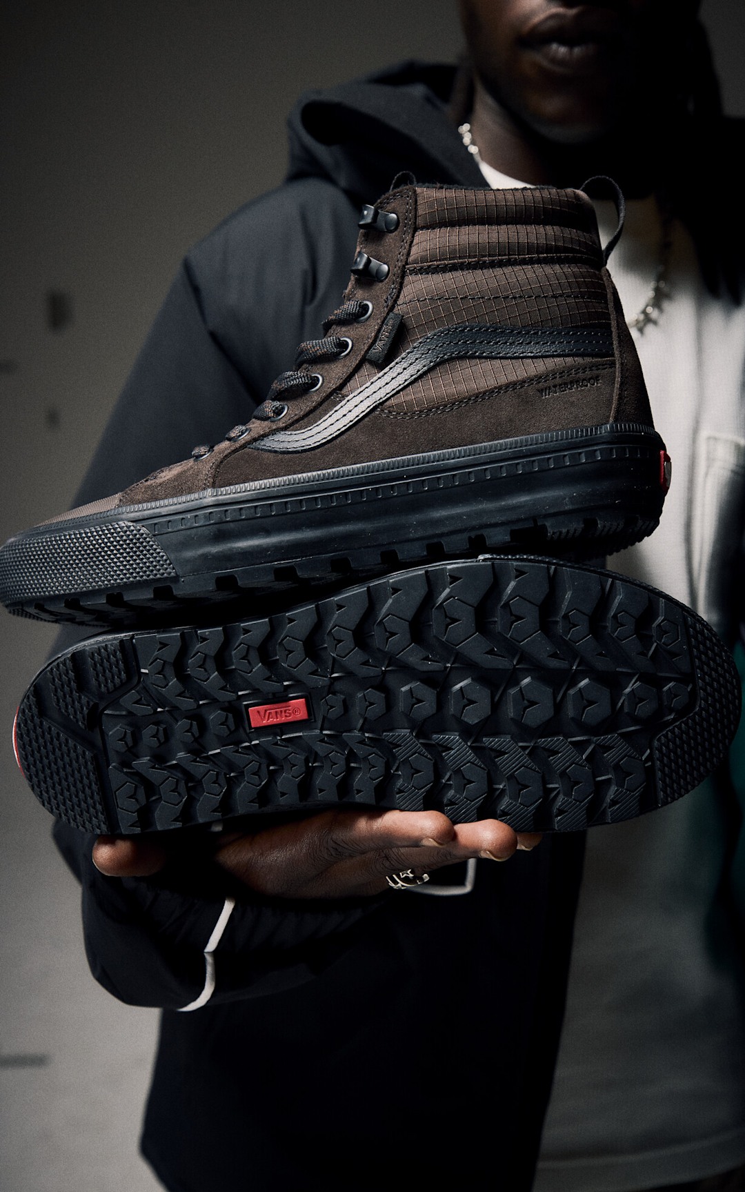 A close up image of a man holding a weatherized sk8 hi shoe