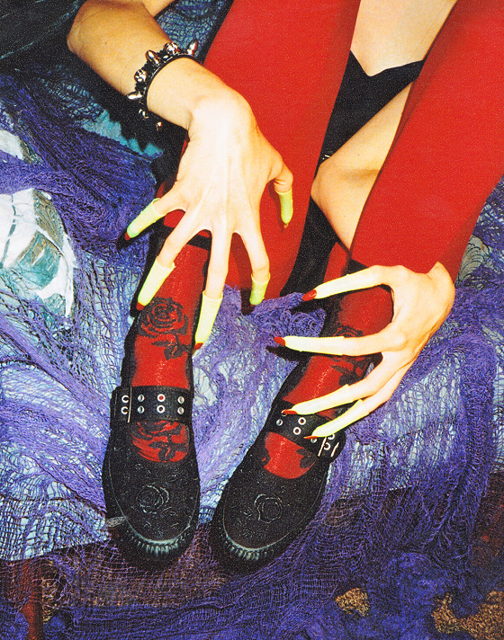Knee down close up shot of a woman wearing red leggings with a pair of the Mary Jane Creeper Shoe in Spooky Black.