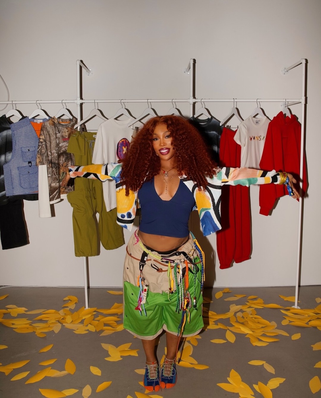 SZA standing in front of the Vansza collection at Vans Store in NYC during NYFW, while wearing Vansza Outdoor Oversized Short and Vansza LX Tabi Hiker.