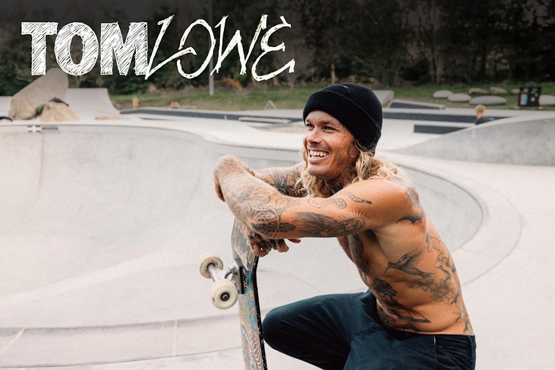 Vans athlete Tom Lowe squatting with a skateboard in a skatepark.