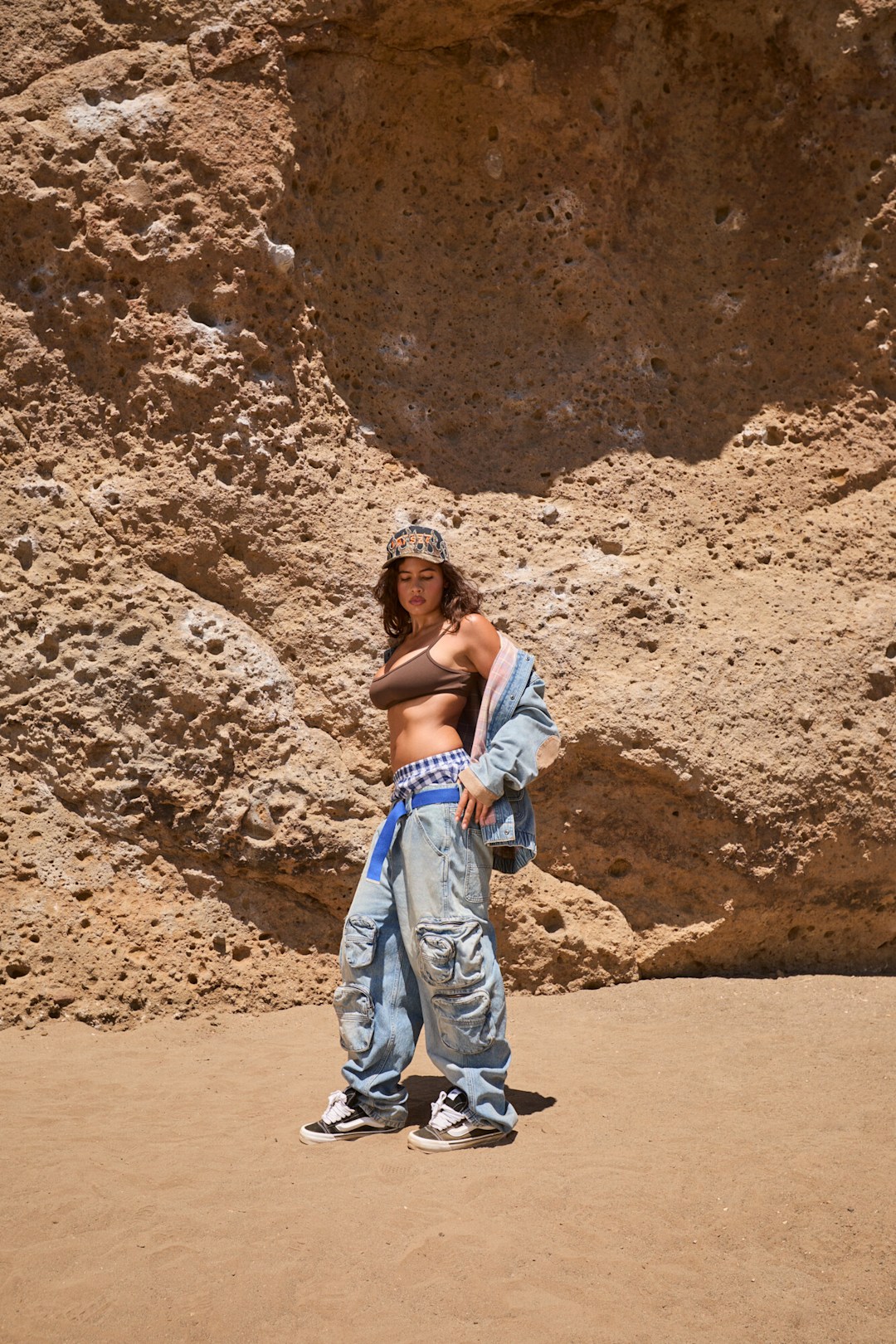 Isabella Carr wearing VANSZA Denim Hunting Jacket and Multi-Pocket Denim Pant on body with Vansza Knu Skool mule and Snapback Hat.