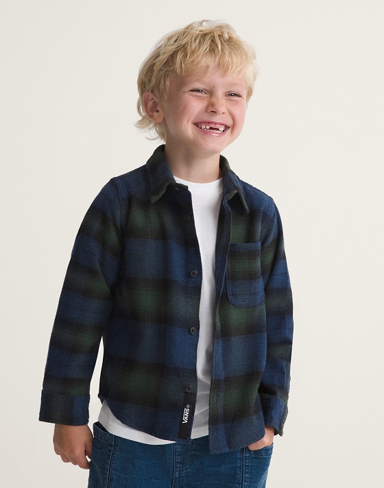 A young boy wearing a blue and green Lawson Flannel Plaid shirt in a photo studio.