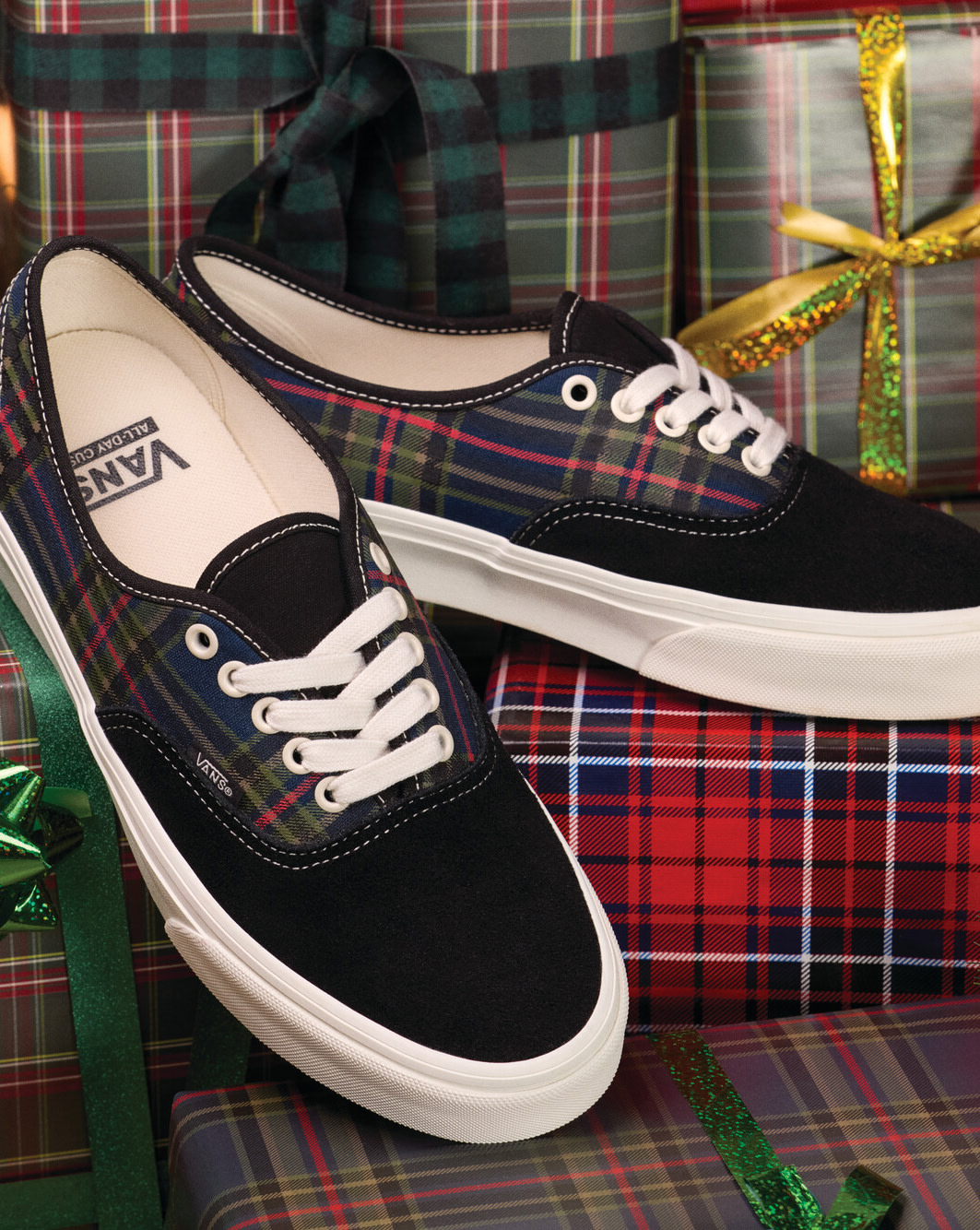 Plaid Vans Authentic shoes displayed among wrapped holiday gifts with tartan-pattern gift wrap and the text "Festive".