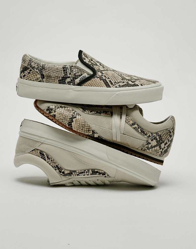 A Python Turtledove White Classic Slip-On, Super Lowpro, and Old Skool lying stacked on each other in a photo studio.