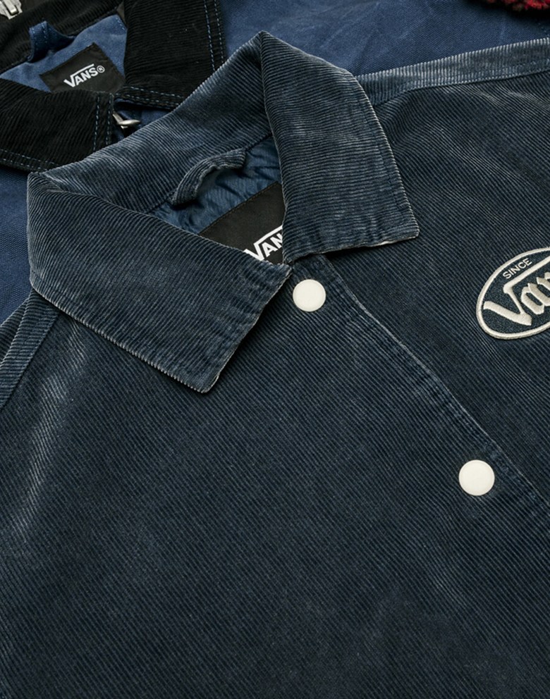 A blue corduroy Milliken Varsity Jacket lying on top of a blue Nico Cropped Chore Canvas Jacket.