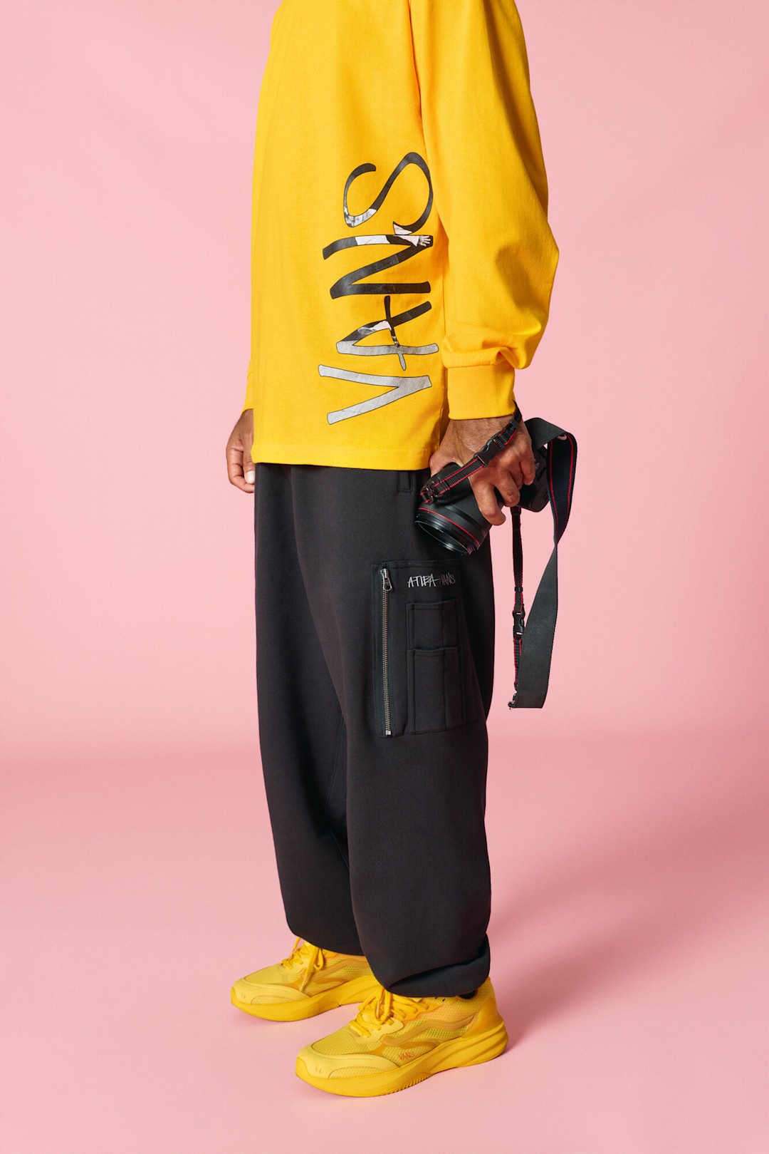 Lauren Halsey wearing Atiba collection from top to bottoms while holding a camera in her left hand.