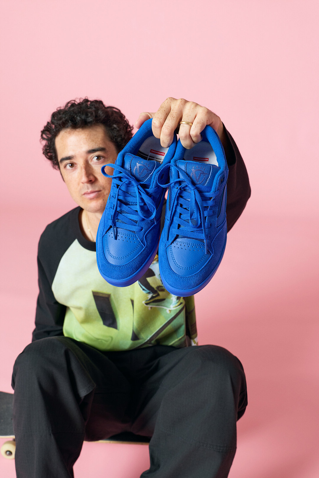 Rowan Zorilla holding up a pair of Skare Rowan Z3 shoes.