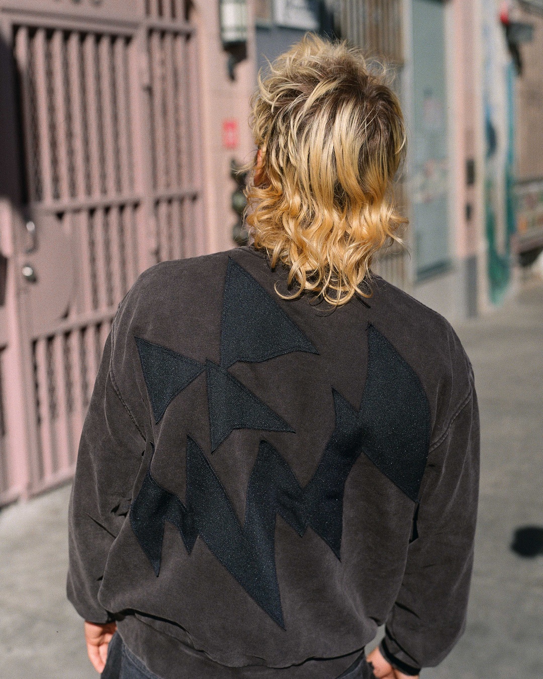 View of the back of OTW x Bad Idea by CHTIO washed black crewneck.