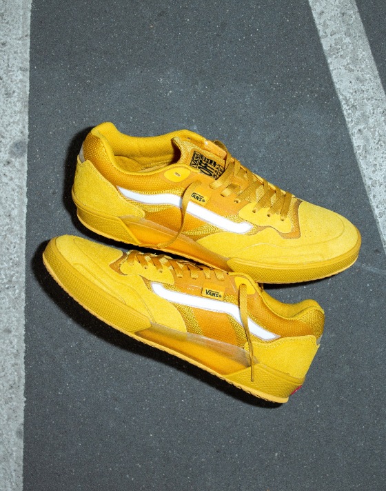 Two yellow AVE 2.0 shoes with a reflective white Sidestripe on the asphalt.