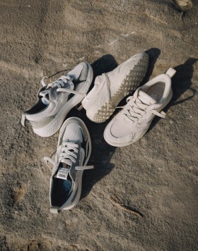 Two pairs of the MTE UltraRange on the ground, one all white and the other white and gray.
